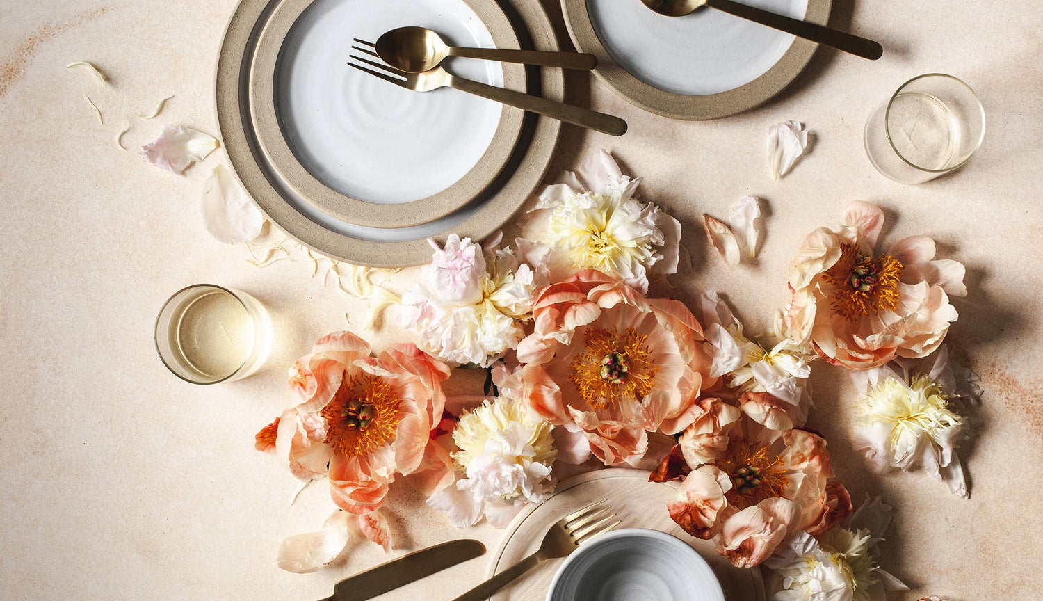 Beautiful image of farmhouse pottery plates and floral tablescape