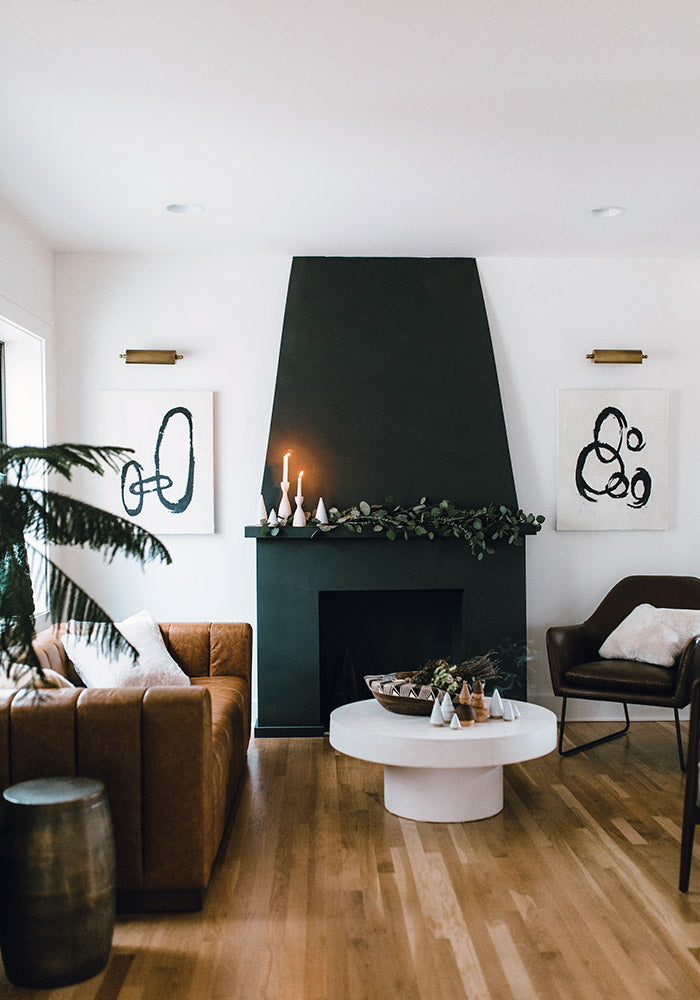 A living room setting with fireplace and assorted pottery decor