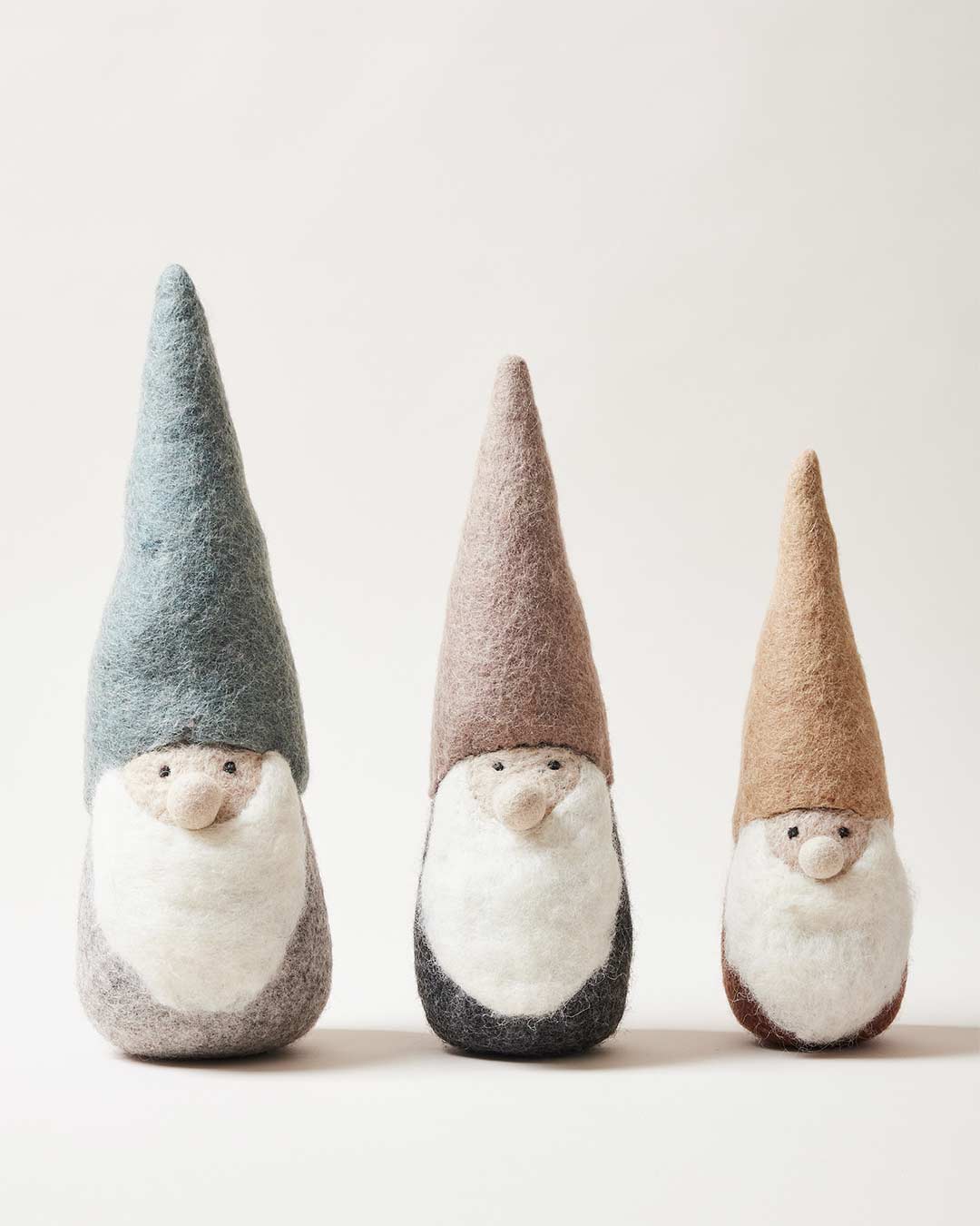 http://www.farmhousepottery.com/cdn/shop/products/felted-woodland-gnome-group-in-a-line_1080x.jpg?v=1696271178